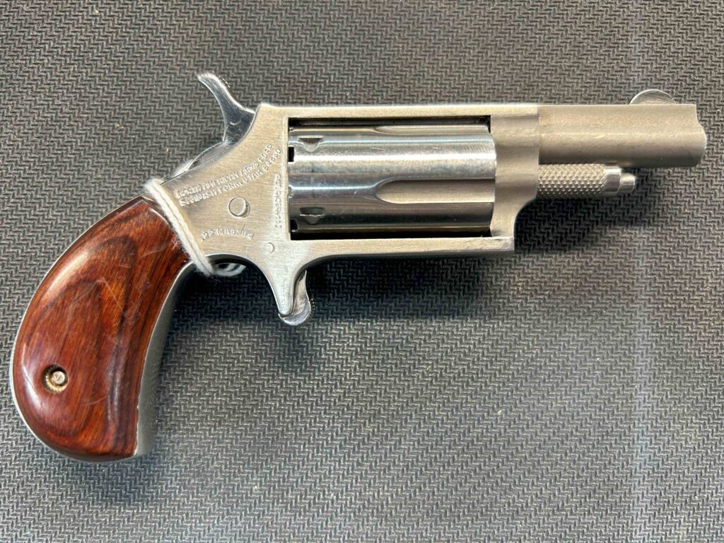 The North American Arms Mini .22 Magnum Revolver is a single action revolver with a 5-round capacity. It has a Rosewood Bird's Head grip and a 1.63-inch barrel. Features and Benefits Single action with a 5-round capacity 1.63-inch barrel Rosewood Bird's Head grip Specifications Action: Single Grip: Rosewood Bird's Head Product weight: 6.5 oz. Manual Safety: No Product length (in.): 5.13